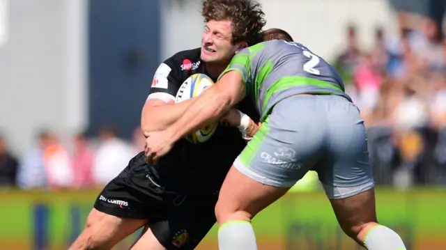 Kyle Cooper of Newcastle tackles Alec Hepburn of Exeter