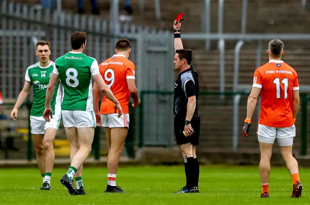 Armagh midfielder Niall Grimley is shown the red card by referee Paddy Neilan