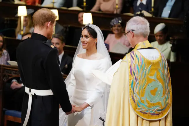 Archbishop Justin Welby performs the service as Meghan and Harry hold hands