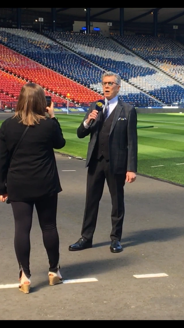 Legendary boxing ring announcer Michael Buffer gets a feel for the microphone pitchside at Hampden.