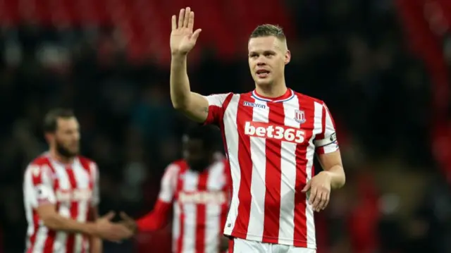 Ryan Shawcross in Stoke shirt with hand raised