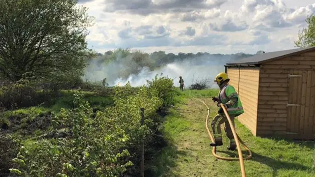 Fire crew tackling grass fire