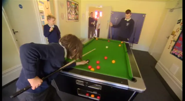 Pupils playing a game of pool