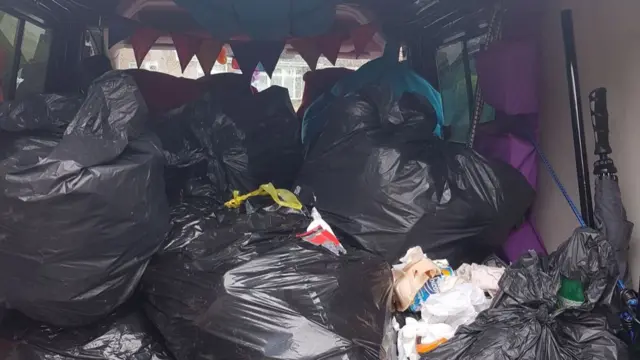 Bags of rubbish left in back of van