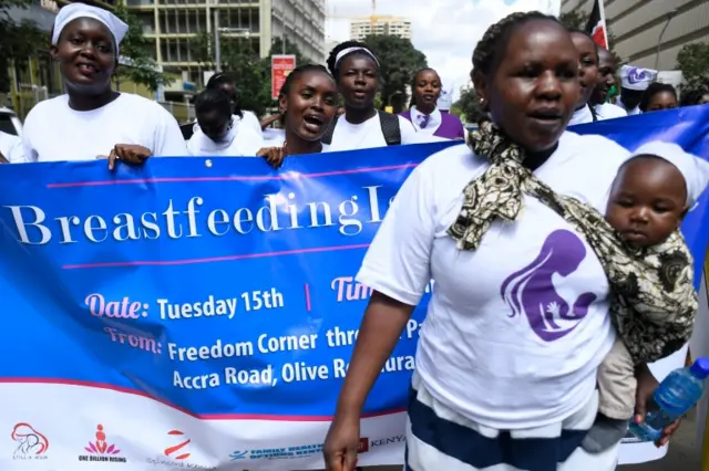 A group of protesters march towards a restaurant after a female client was allegedly thrown out for breastfeeding and not covering up in Nairobi"s central business district on 15 May 2018