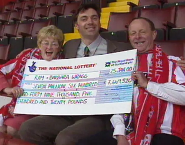 Barbara and Ray Wragg with their cheque and BBC reporter