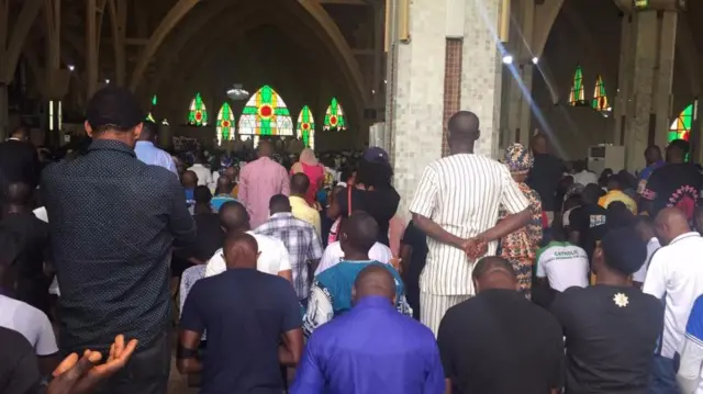 Christians in Abuja, Nigeria, praying in church