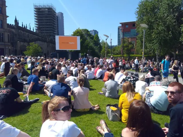 Crowds gather to watch Memorial service on big screen