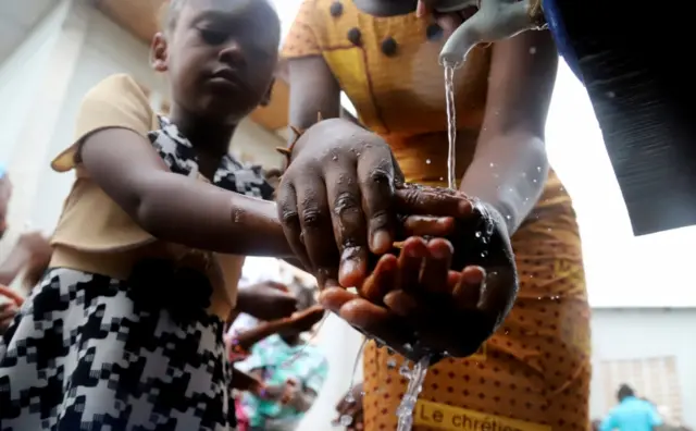 A Congolese child washes her hands as a preventive measure against Ebola at the Church of Christ in Mbandaka, Democratic Republic of Congo May 20, 201