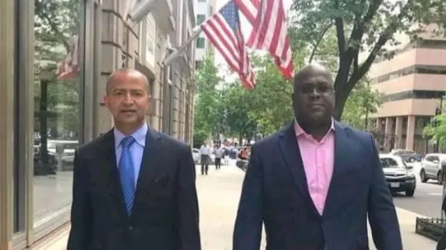 Moise Katumbi and Felix Tshisekedi walking down a street in the US