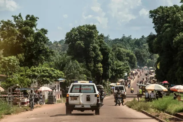 An ambulance carries the remains of an Ebola victim towards a burial site in Mbandaka on May 22, 2018,