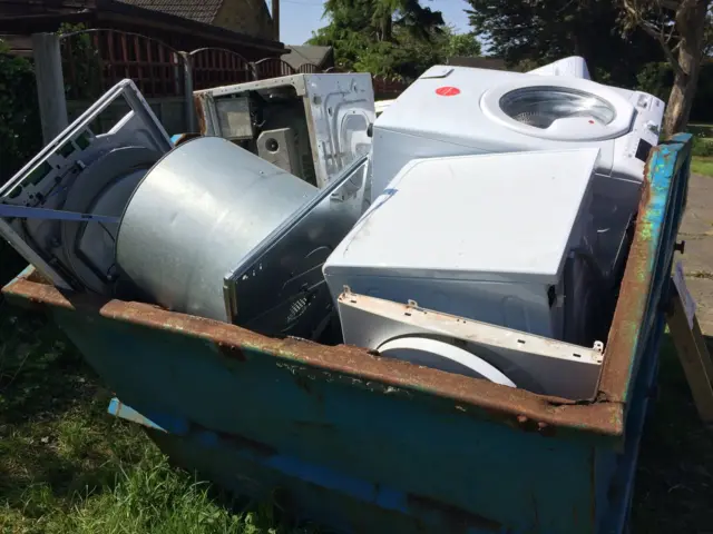 Skip filled with washing machines