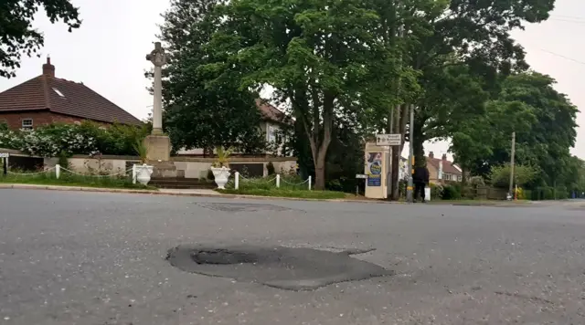 Hole in road