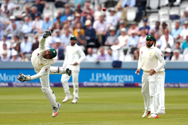 Pakistan's Sarfraz Ahmed dives to catch a ball