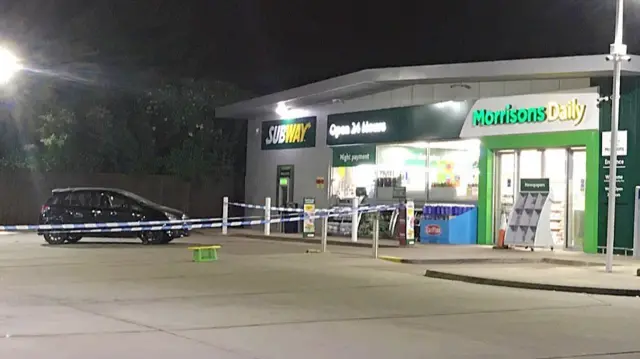 Police tape at petrol station