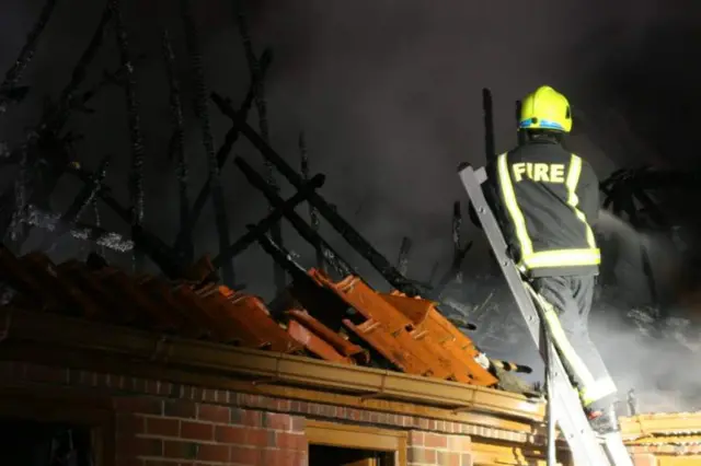 Firefighter tackling fire