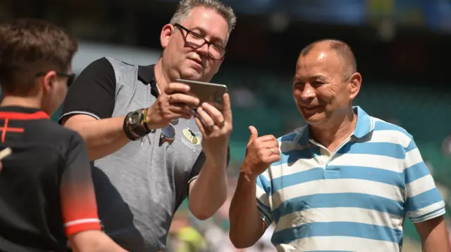 England Head Coach Eddie Jonesposes for pictures with fans