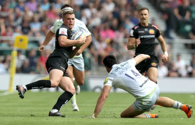 Joe Simmonds of Exeter Chiefs moves away from Sean Maitland of Saracens