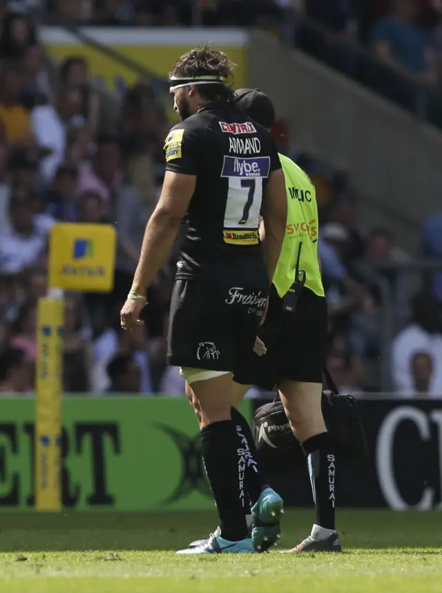 Don Armand leaves the pitch with an injury