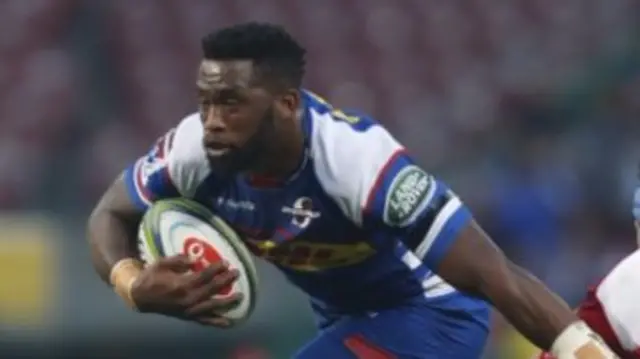 Siya Kolisi (L) from the Stormers breaks through a tackle from Lourens Erasmus (R) from the Lions during their Super Rugby match in Cape Town, South Africa 26 May 2018