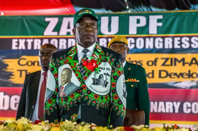 Zimbabwe's President Emmerson Mnangagwa sings the national athem at the start of the extraordinary conference of the Zanu-PF, Zimbabwe's ruling party, in Harare December 15, 2017