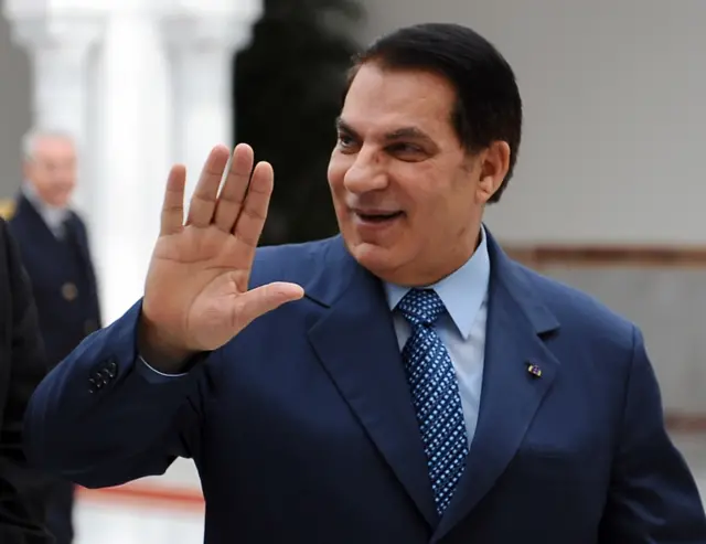 Zine El Abidine Ben Ali waves as he welcomes Tunisian swimming Olympic champion Oussama Mellouli upon arrival at Tunis-Carthage airport on December 22, 2010