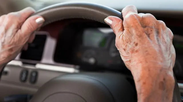 Elderly woman driving car