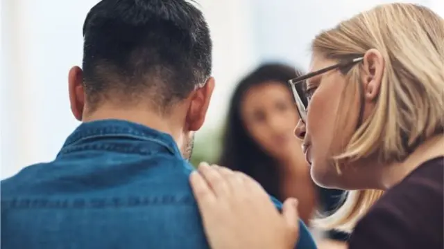 Man being comforted by woman