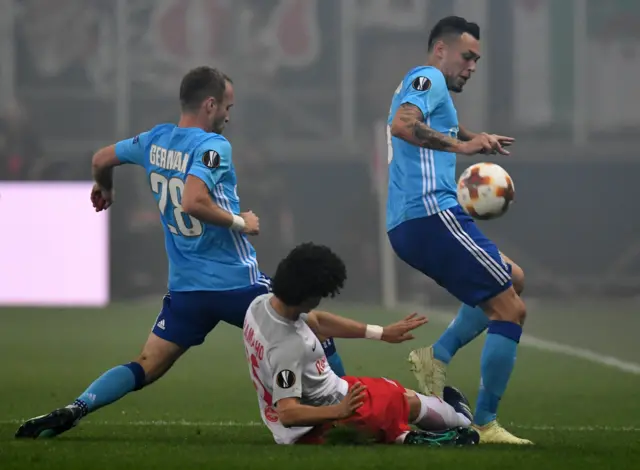 Marseille's Valere Germain and Lucas Ocampos tackle Salzburg defender Andre Ramalho