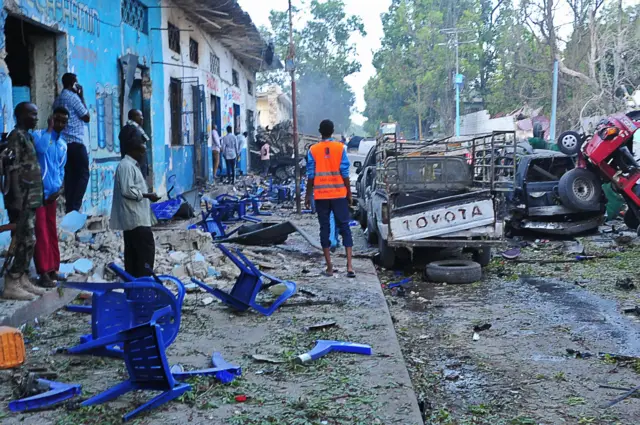 People look on at the aftermath of the 28 October bombing