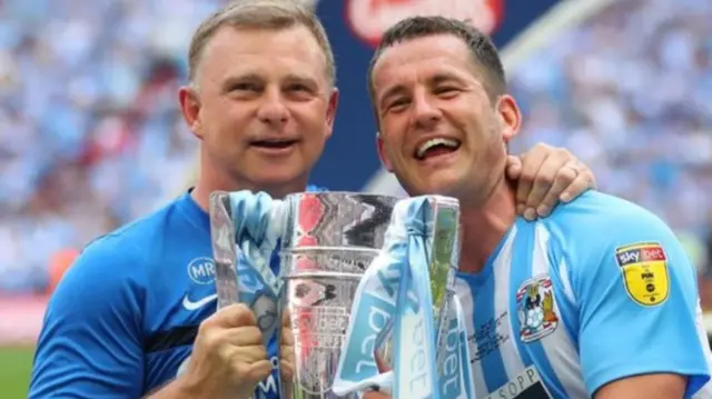 Mark Robins and captain Michael Doyle celebrate Coventry's victory