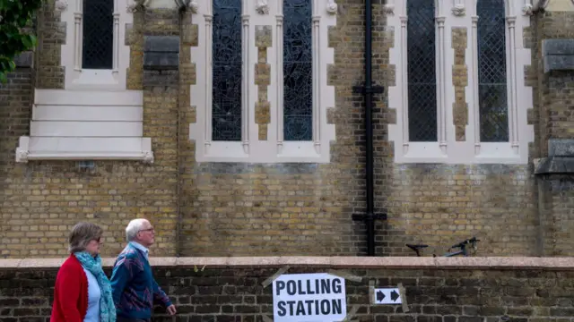 Voters walk into polling station in a church in Twickenham