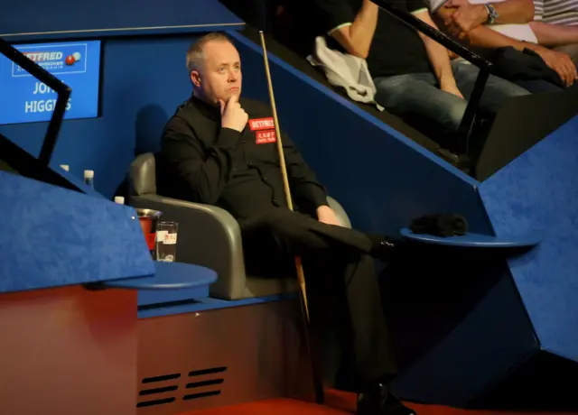 John Higgins watches on