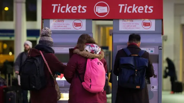 PEOPLE AT TICKET MACHINES