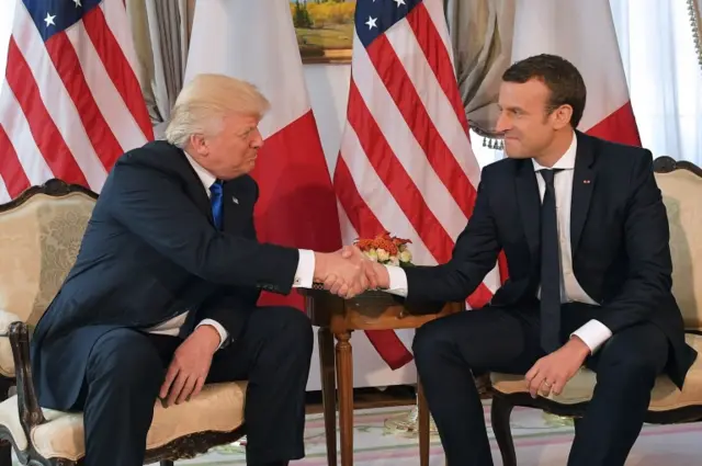 Trump (left) shakes hands with Macron