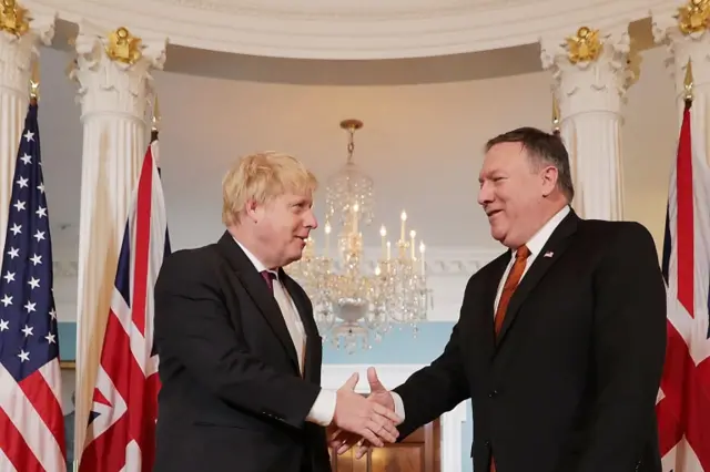 Boris Johnson (left) shakes hands with Mike Pompeo