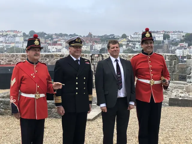 Vice Admiral Sir Simon Lister with Jason Monaghan from Guernsey Museums and two Castle Keepers