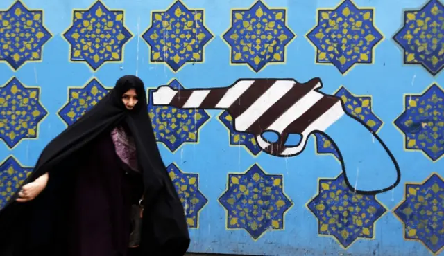 Iranian woman in front of the former US embassy in Tehran