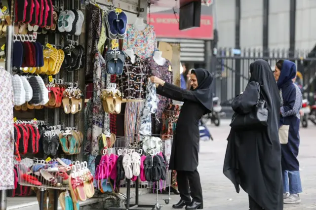 An Iranian woman browses a market in Tehran on 8 May 2018