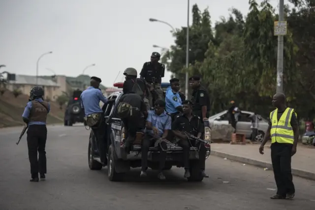 Members of the Nigerian police pursue protesters from the Islamic Movement of Nigeria (IMN) in Abuja on April 17, 2018