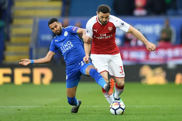 Riyad Mahrez of Leicester City tackles Sead Kolasinac