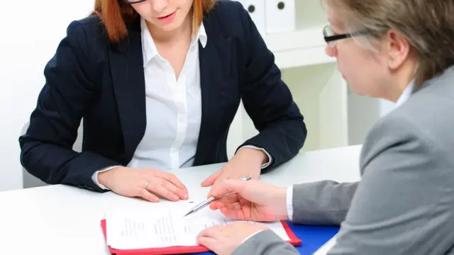 Two women looking at a document