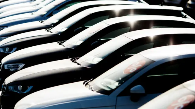 Second-hand Audi passenger cars stand on display at an Audi dealership