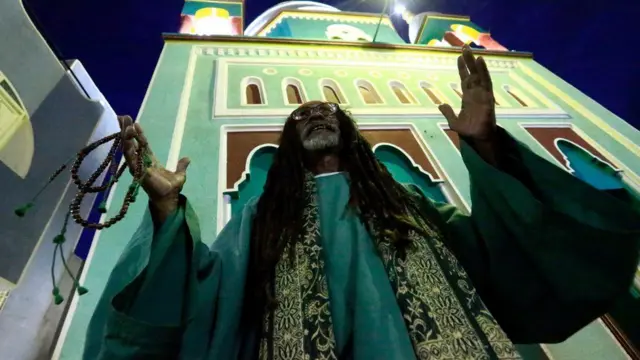 Three days earlier, a man is pictured praying after breaking his Ramadan fast at the Sheikh Dafallah Mosque in the Sudanese capital Khartoum