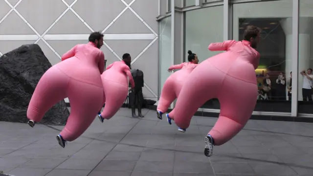 Dancers in inflatable suits