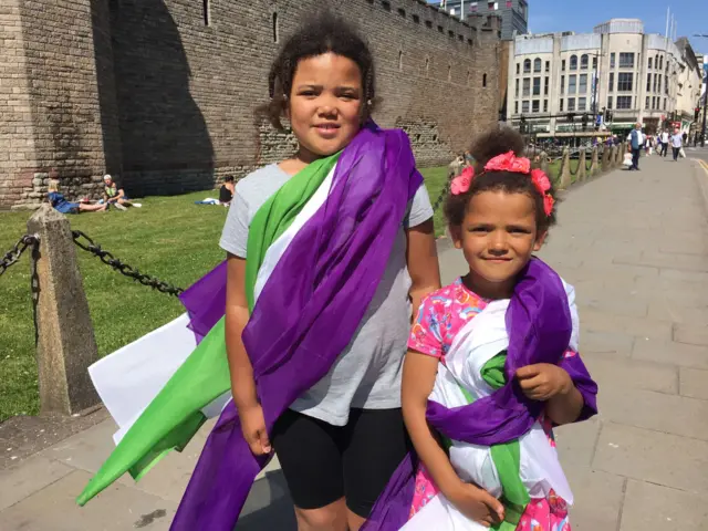 Leona and Bella from Cardiff wearing scarves in the colours of the suffrage movement