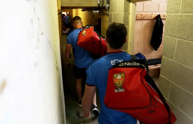 Members of the Down team enter the Clones changing rooms