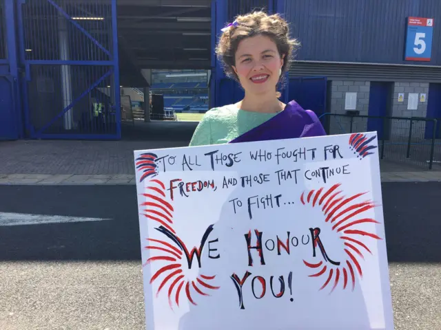 Nessie Reid holding her banner at the procession