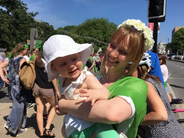 Laura Harris holding her daughter Etta