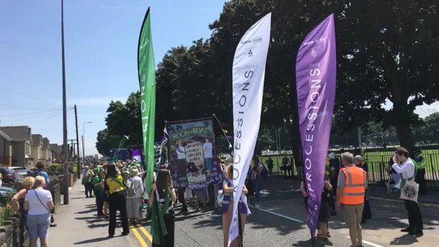 Women with Processions banners near Cardiff City Stadium